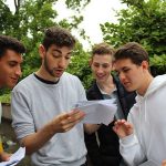 group of boys opening exam results