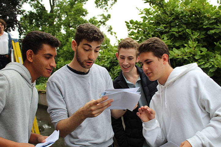 group of boys opening exam results