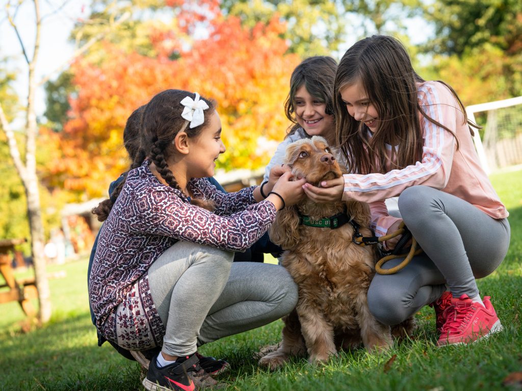 Lower School students with school dog, Alfie