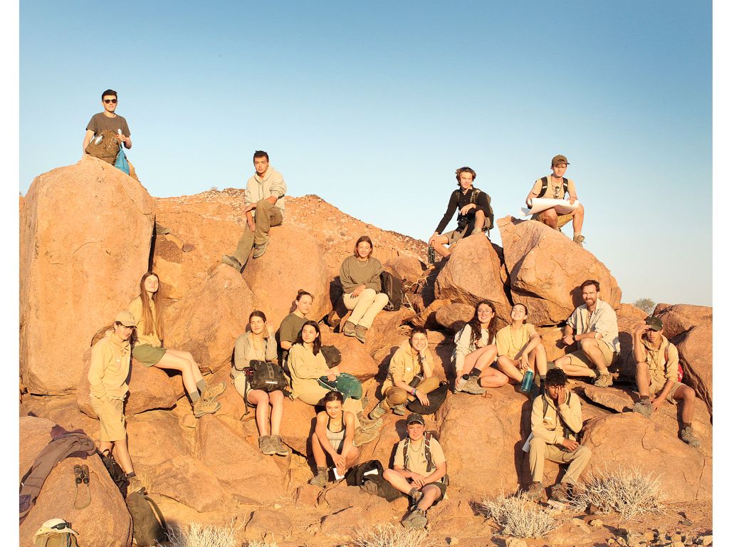 Students sitting on rocks