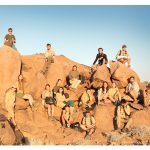 Students sitting on rocks