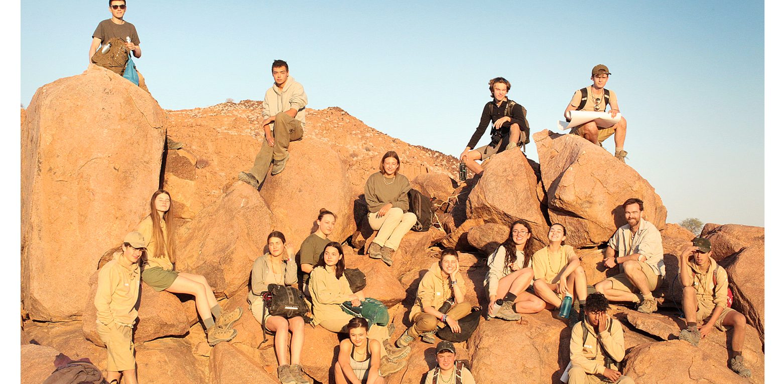 Students sitting on rocks