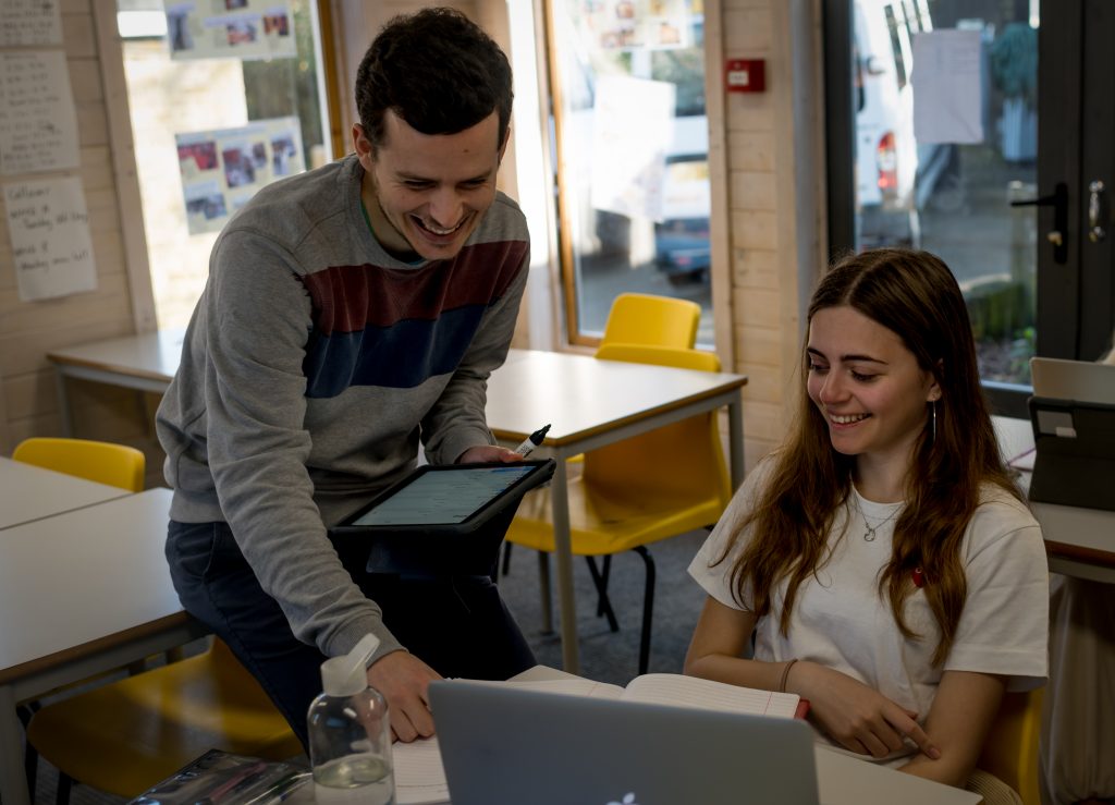 Students Studying with the help of a teacher