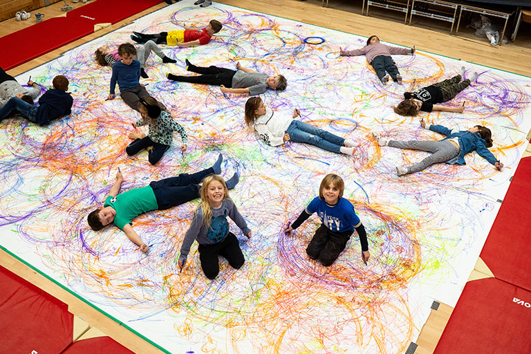 Children lying down on a poster