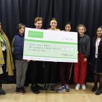students holding a big cheque