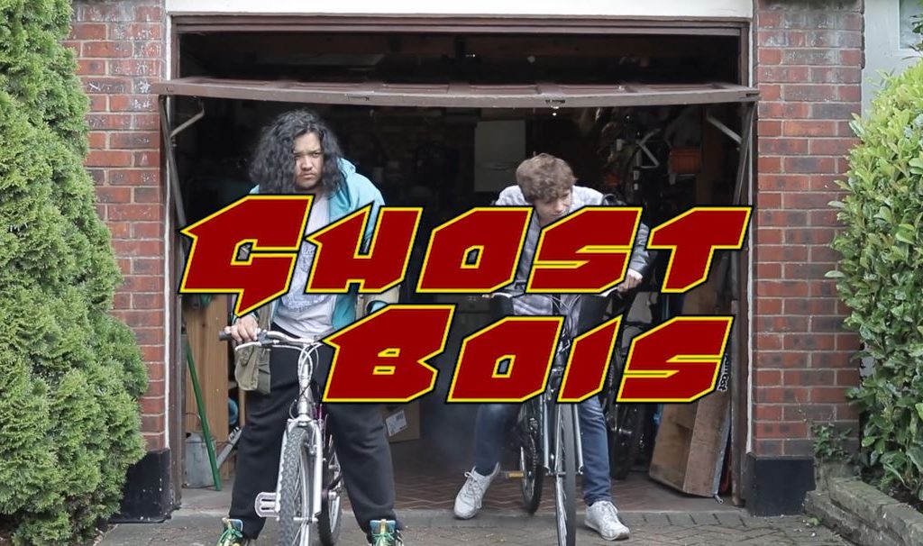 Students riding bikes with red text 'GHOST BOIS'