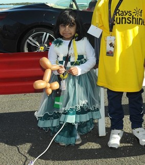 Child holding a balloon dog