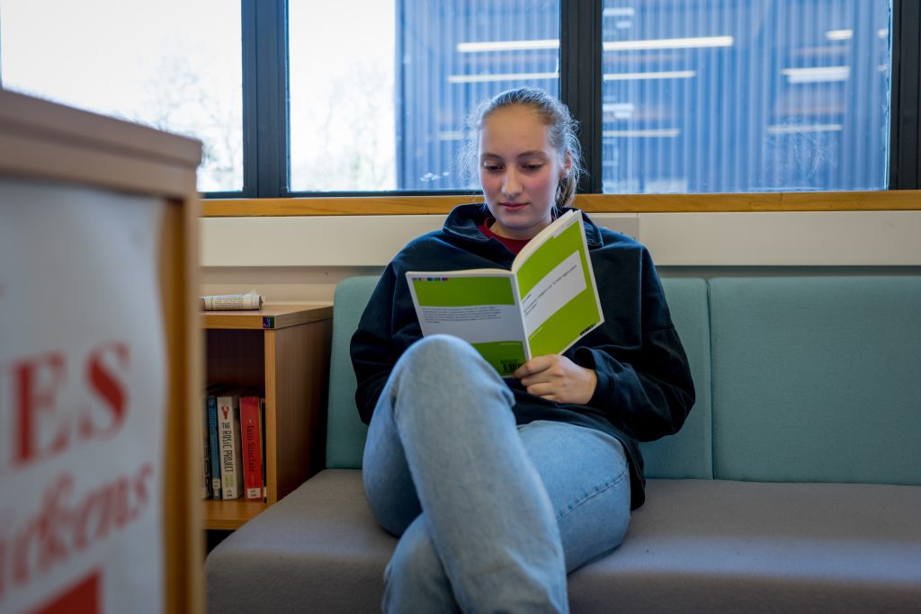 Student reading in the Upper School library