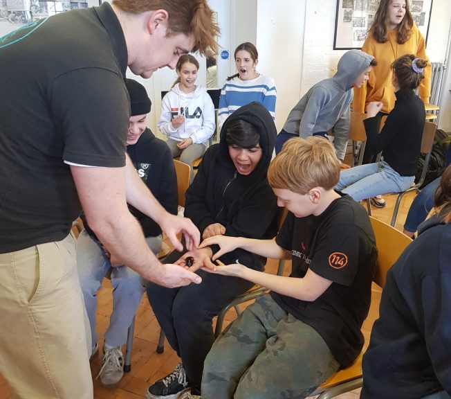 Student holding a bug