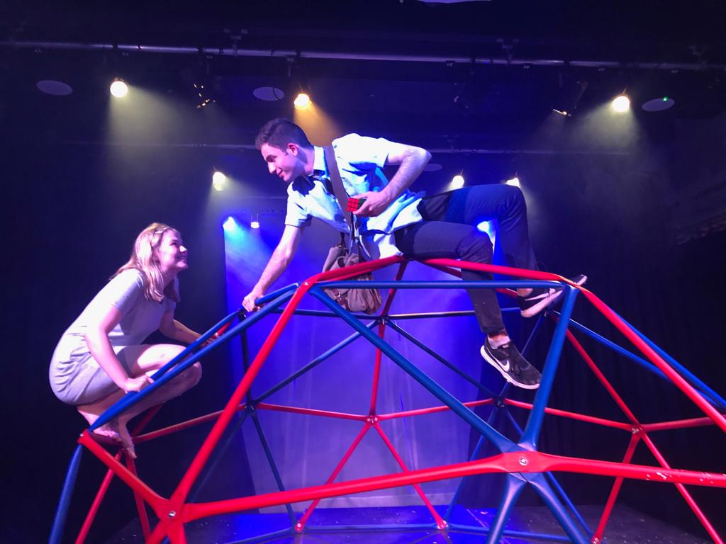 Two students climbing on a structure