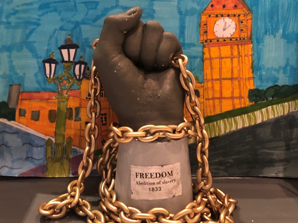 Fist sculpture holding a chain