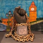 Fist sculpture holding a chain