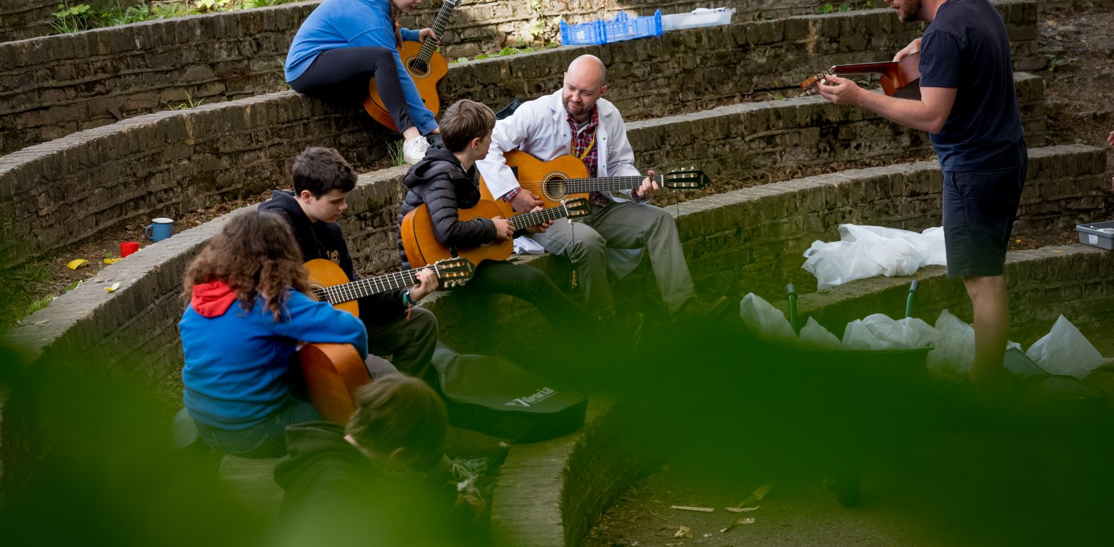 Students and staff playing guitar