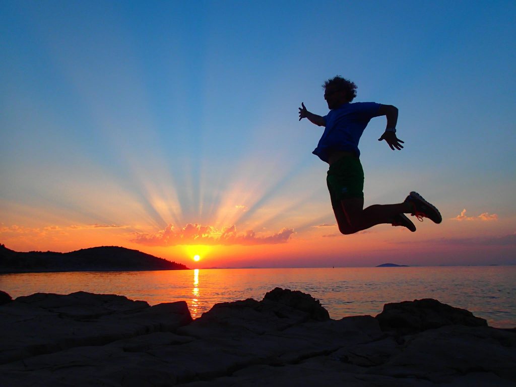 Man jumping with sunset in the background