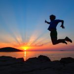 Man jumping with sunset in the background