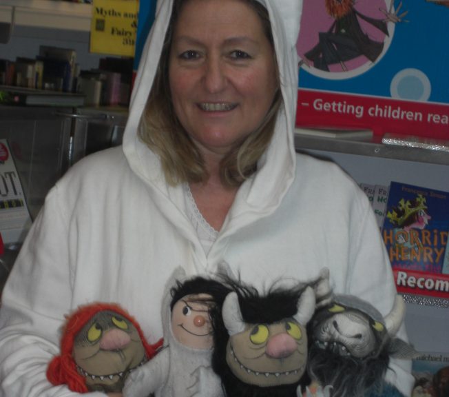Librarian holding four toys