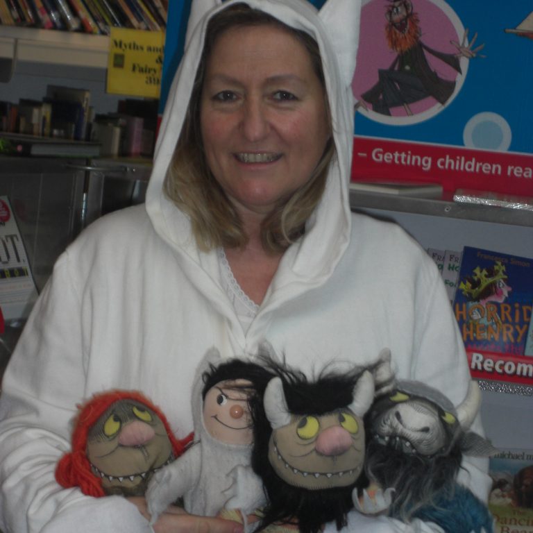 Librarian holding four toys