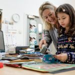 Librarian checking out a library book with a child