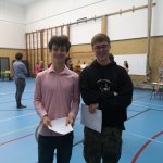 Two students holding exam results