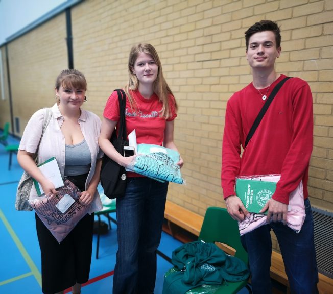 Sixth form students holding hoodies