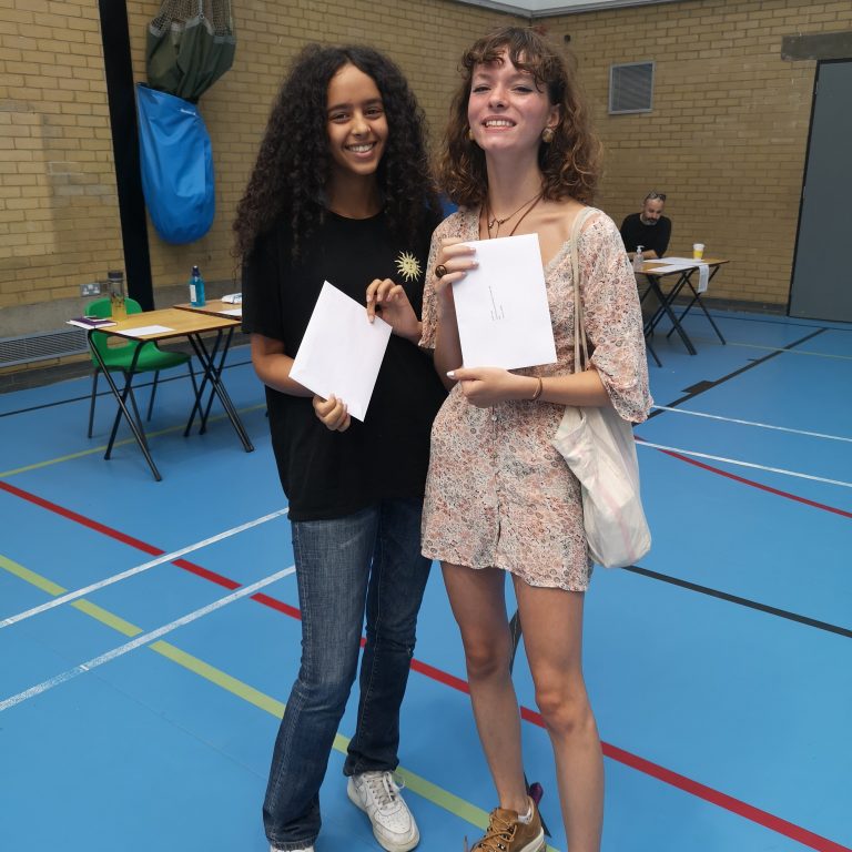 Two students holding exam results