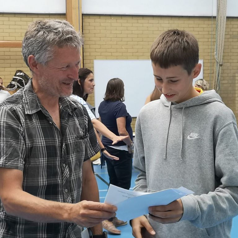 Student and teacher reading exam results