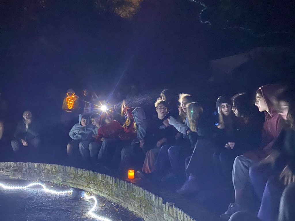 Students sitting outside at night