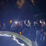 Students sitting outside at night