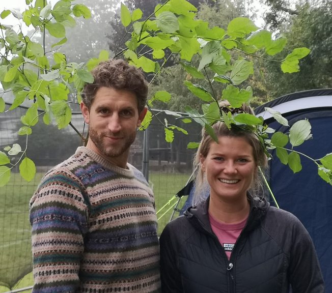 two people wearing leaves on their heads