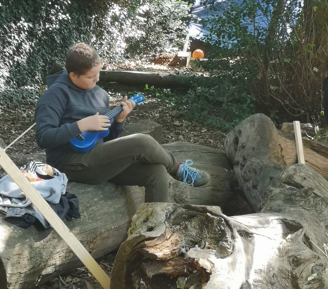 Student playing ukulele