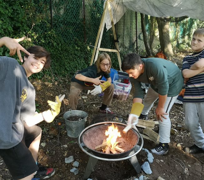 Students standing around a fire