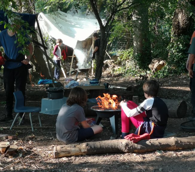 Students sitting around a fire