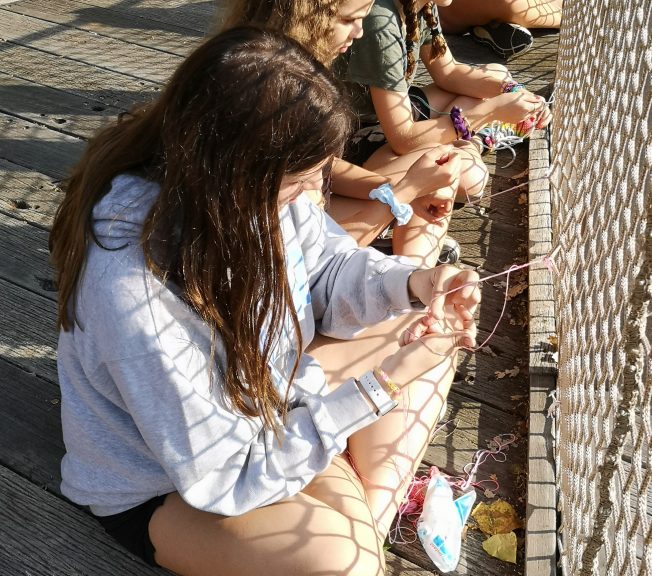 students making friendship bracelets