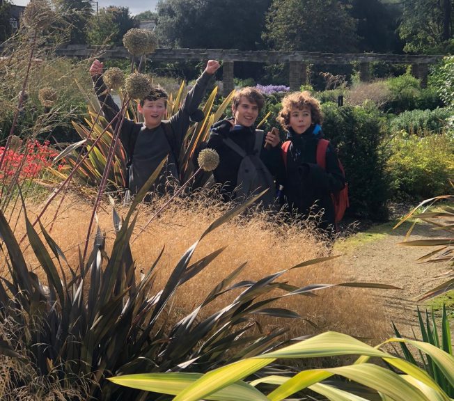 Three students in a garden