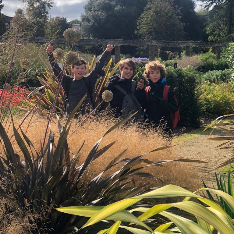 Three students in a garden