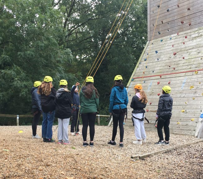 Group photo of students preparing to rock climb