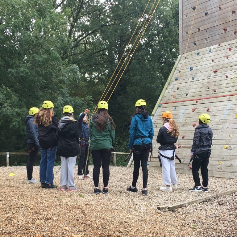 Group photo of students preparing to rock climb