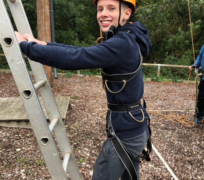 Student about to climb a ladder