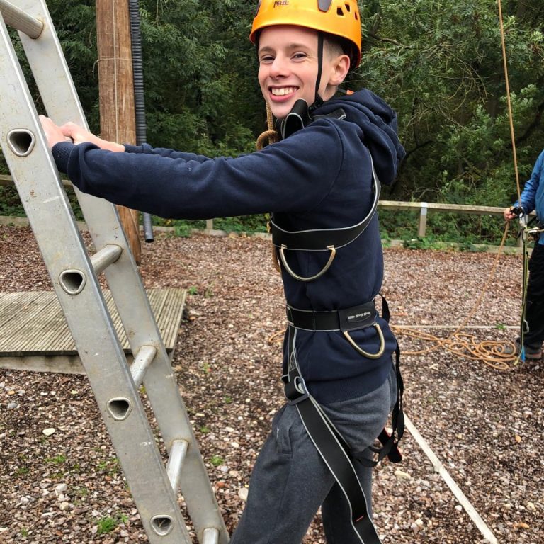 Student about to climb a ladder