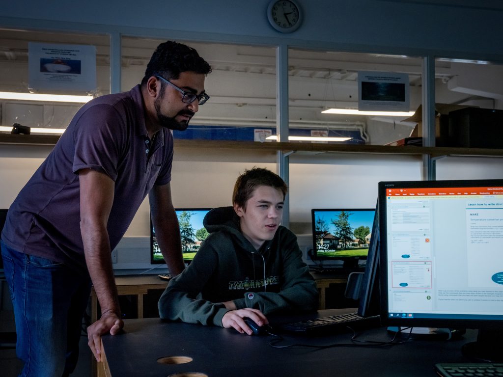 Student working with a teacher in the ICT lab