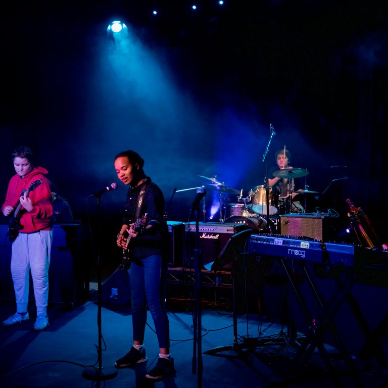 Students singing and playing music for school concert
