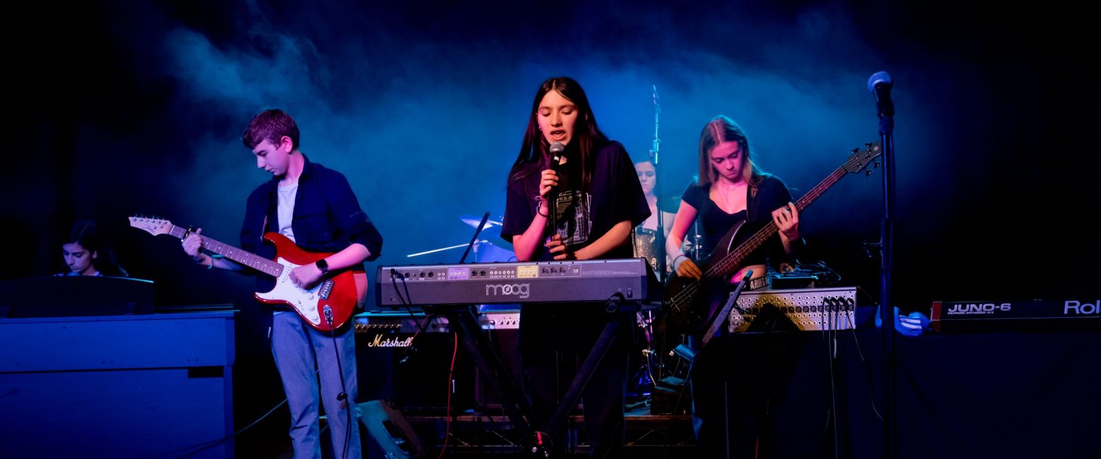 Students singing and playing music for school concert