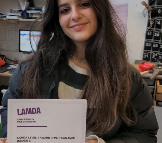 Student holding LAMDA results