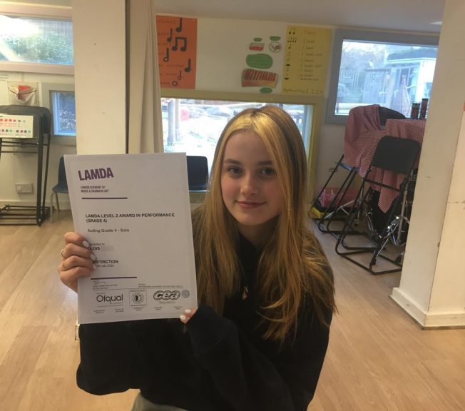 Student holding LAMDA results