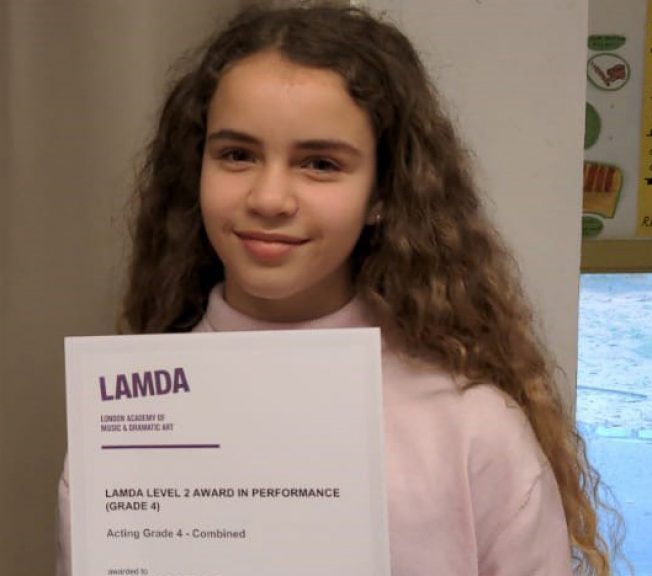 Student holding LAMDA results