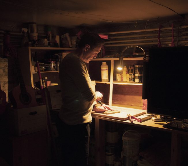 Photograph of a woman carving wood for A Level photography masterclass