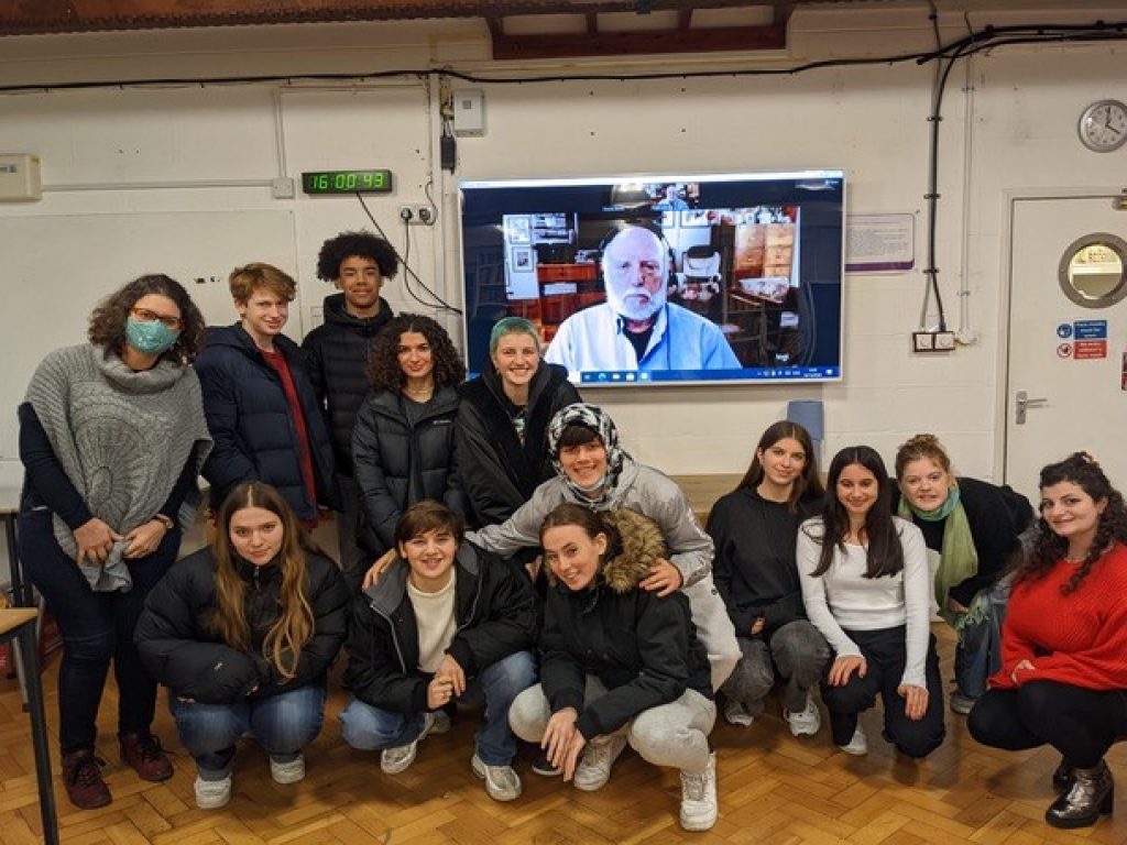 Students and teacher posing with guest speaker