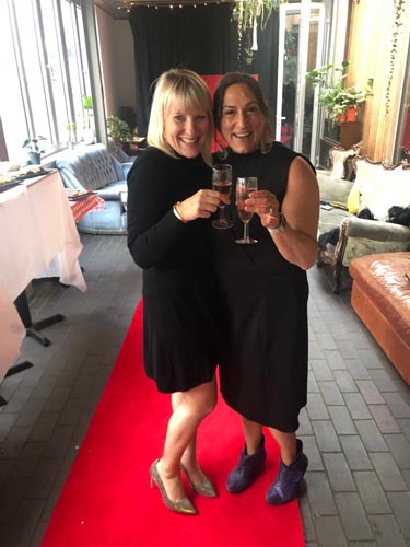 two women on a red carpet