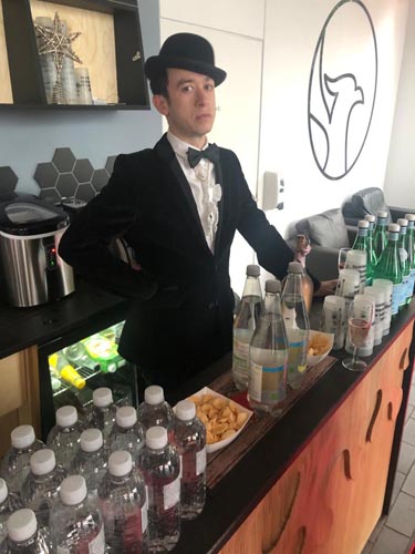 student standing behind a bar