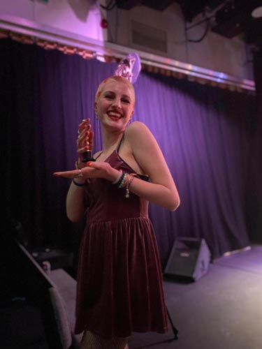 student holding an oscar